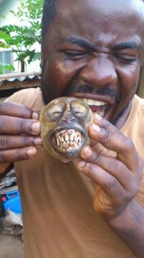 Man eating roasted monkey head.jpg